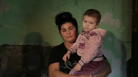 Single mother working from home with her children nearby